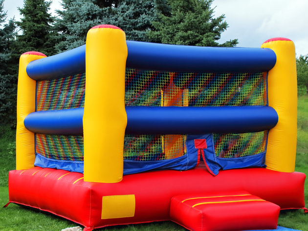 brightly coloured boxing ring style bouncy house