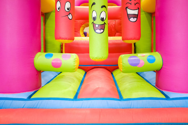 bright and colorful obstacle course with faces on extruding blow up figures