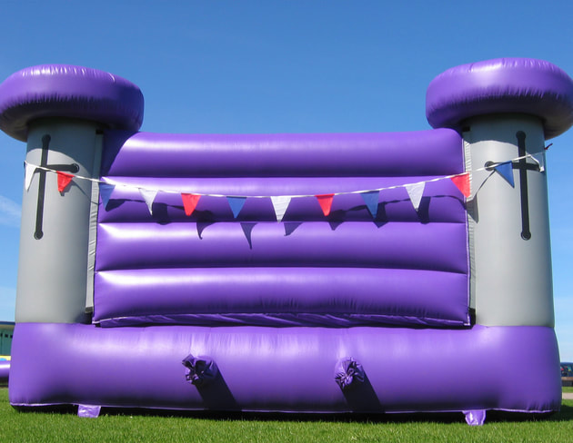 Old medieval style purple and gray bouncy castle  