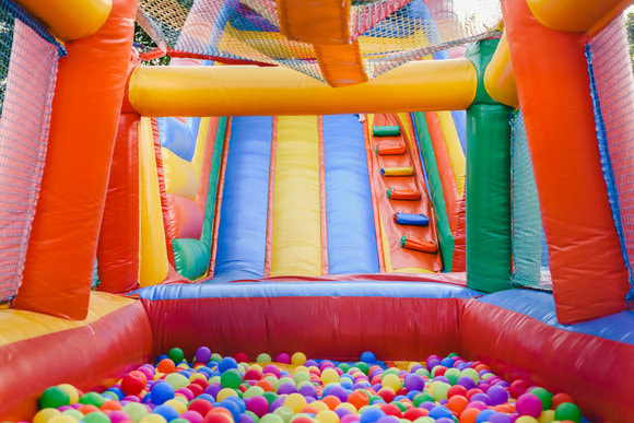 large bouncy castle slide with a ball pit at the end of the slide