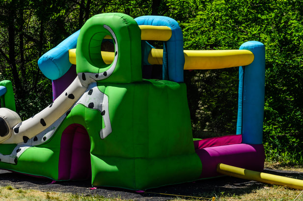 back view of a slide and bouncy house combo